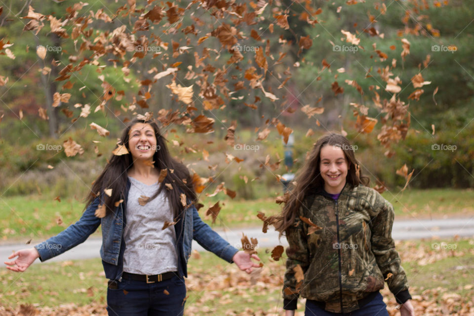 Leaves Falling. My sisters enjoyed being the entertainment and threw leaves into the air without a care.