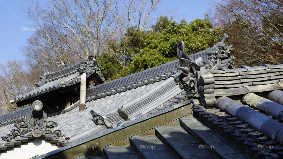 multiple onigawara roof tiles top the rooftops in Nara, Japan