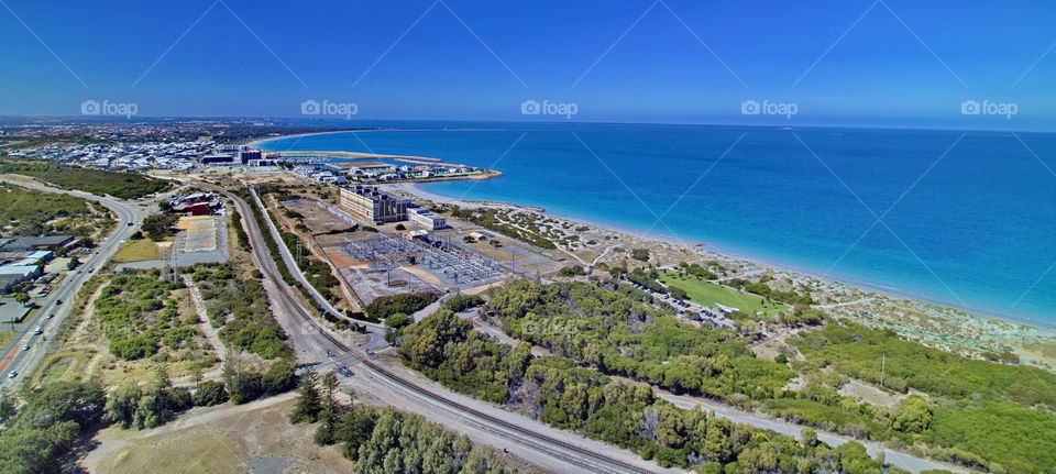 Looking over a bushland at the ocean from above