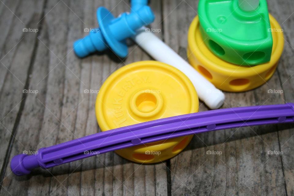 Children’s tinker toys in bright vibrant colors of green, yellow, blue, and purple up close