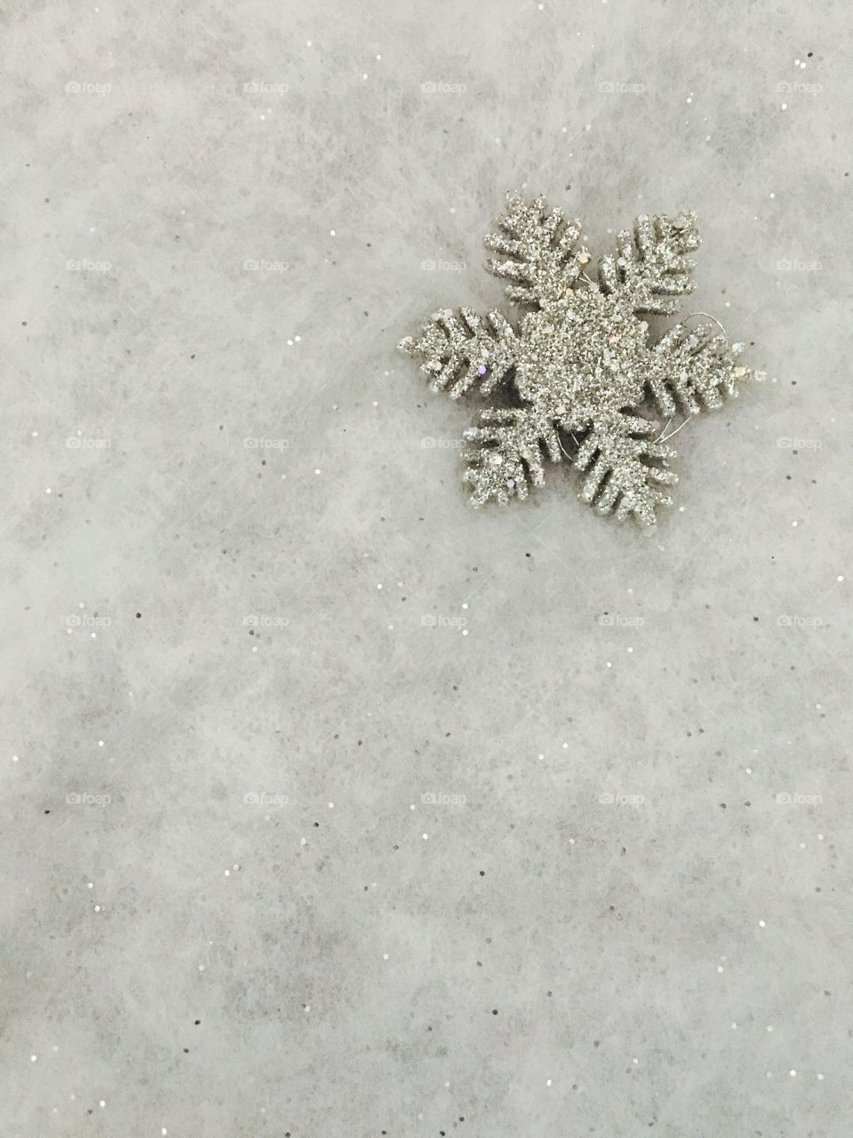 Shiny snowflake jewlery on grey background