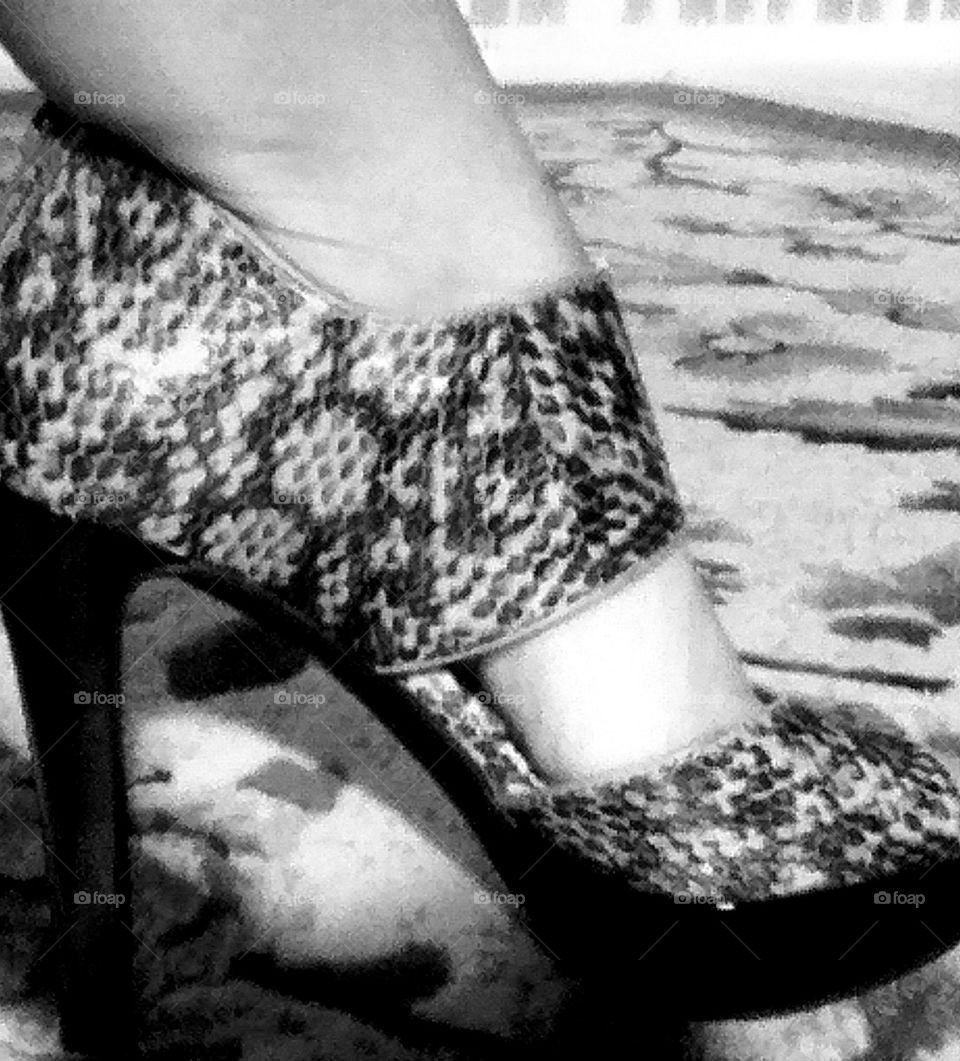 black and white photograph of high heel shoe