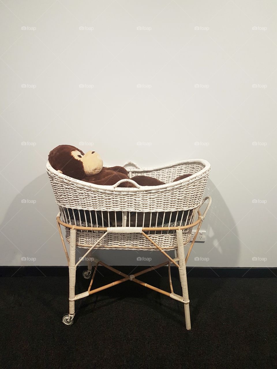 Nursery vintage bassinet with toy monkey
