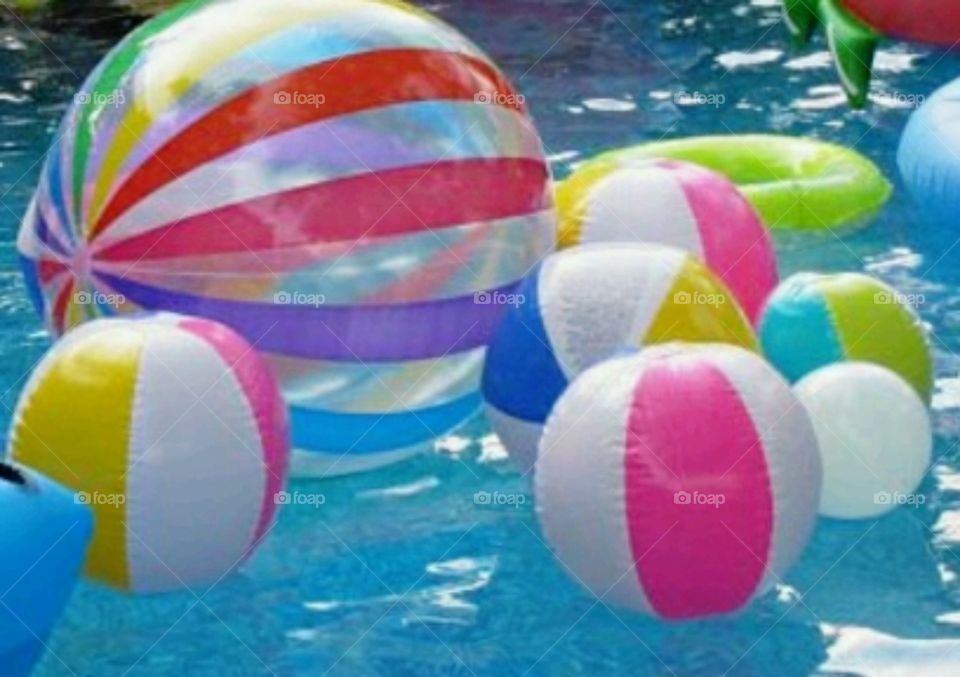 many blowup balls in the pool