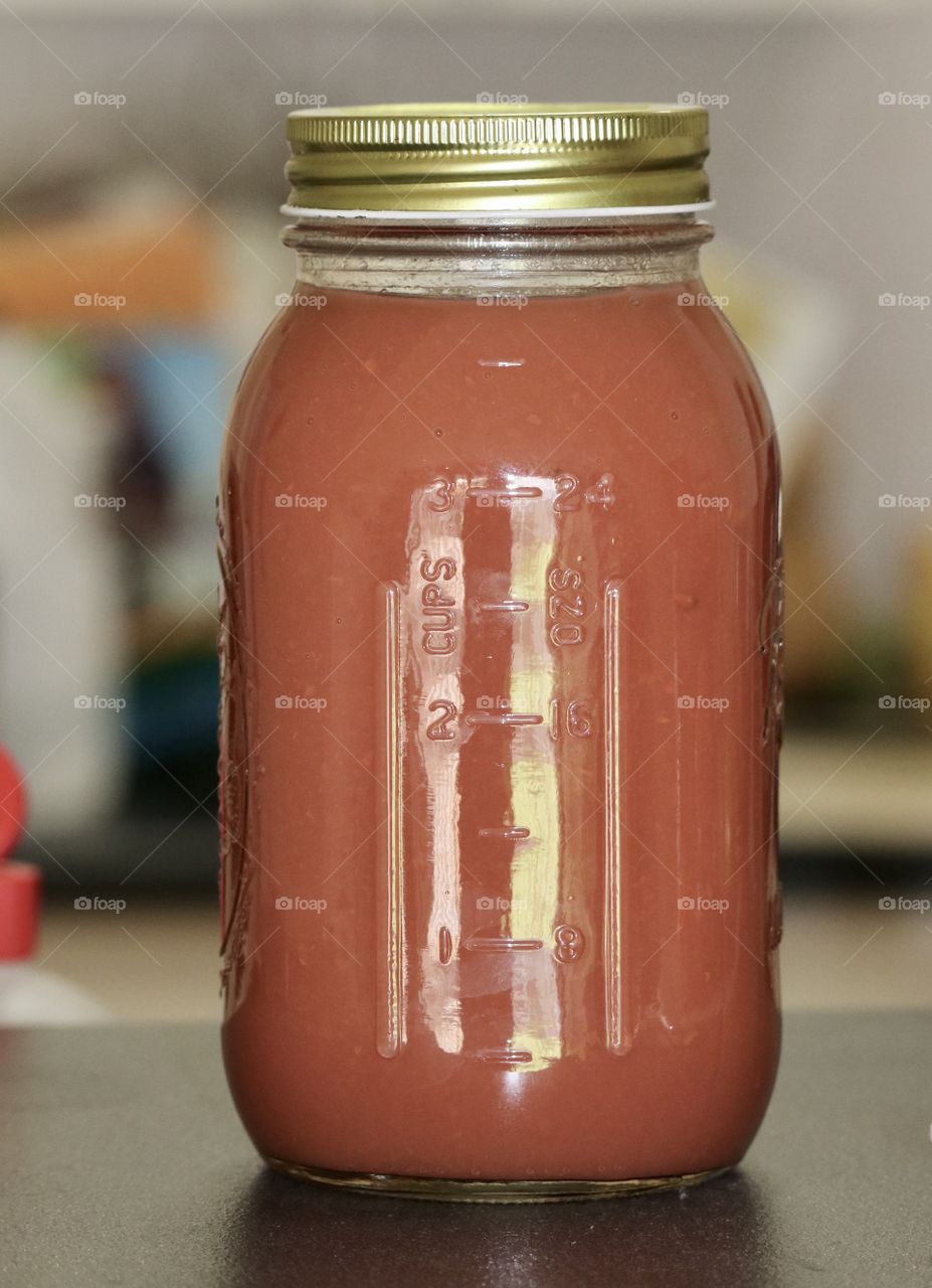 Homemade preserves canning jar filled with quince fruit sauce 