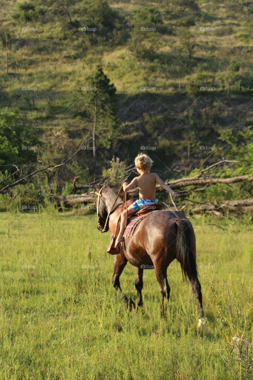 boy riding horse