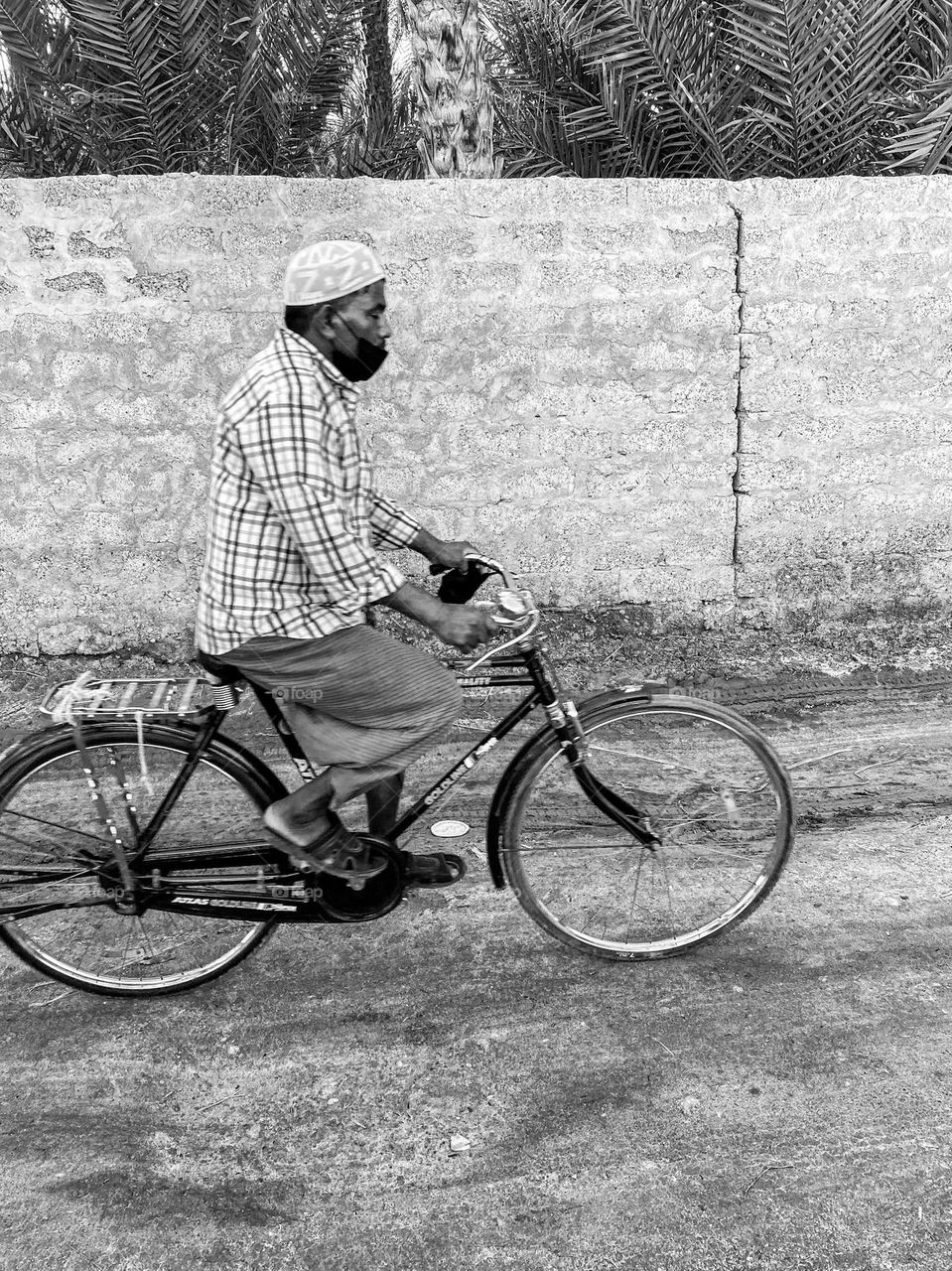A man on a bicycle returning home