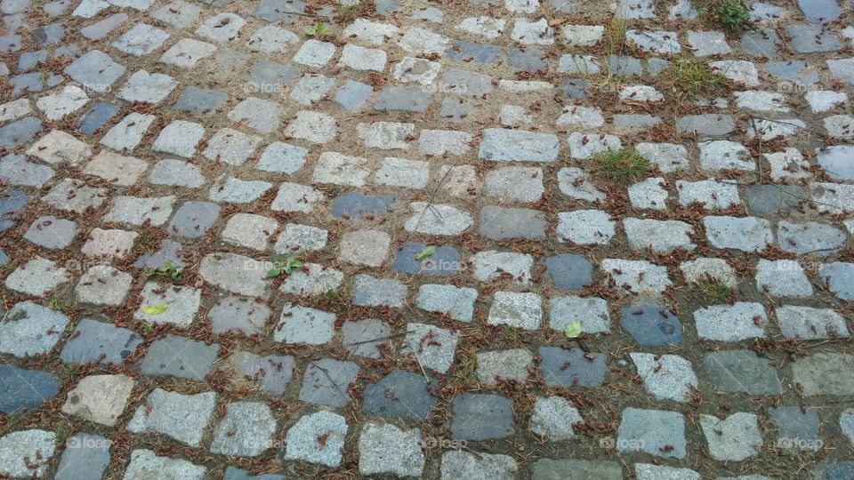 Cubic stone granite pavement. Front pavement of an old Church