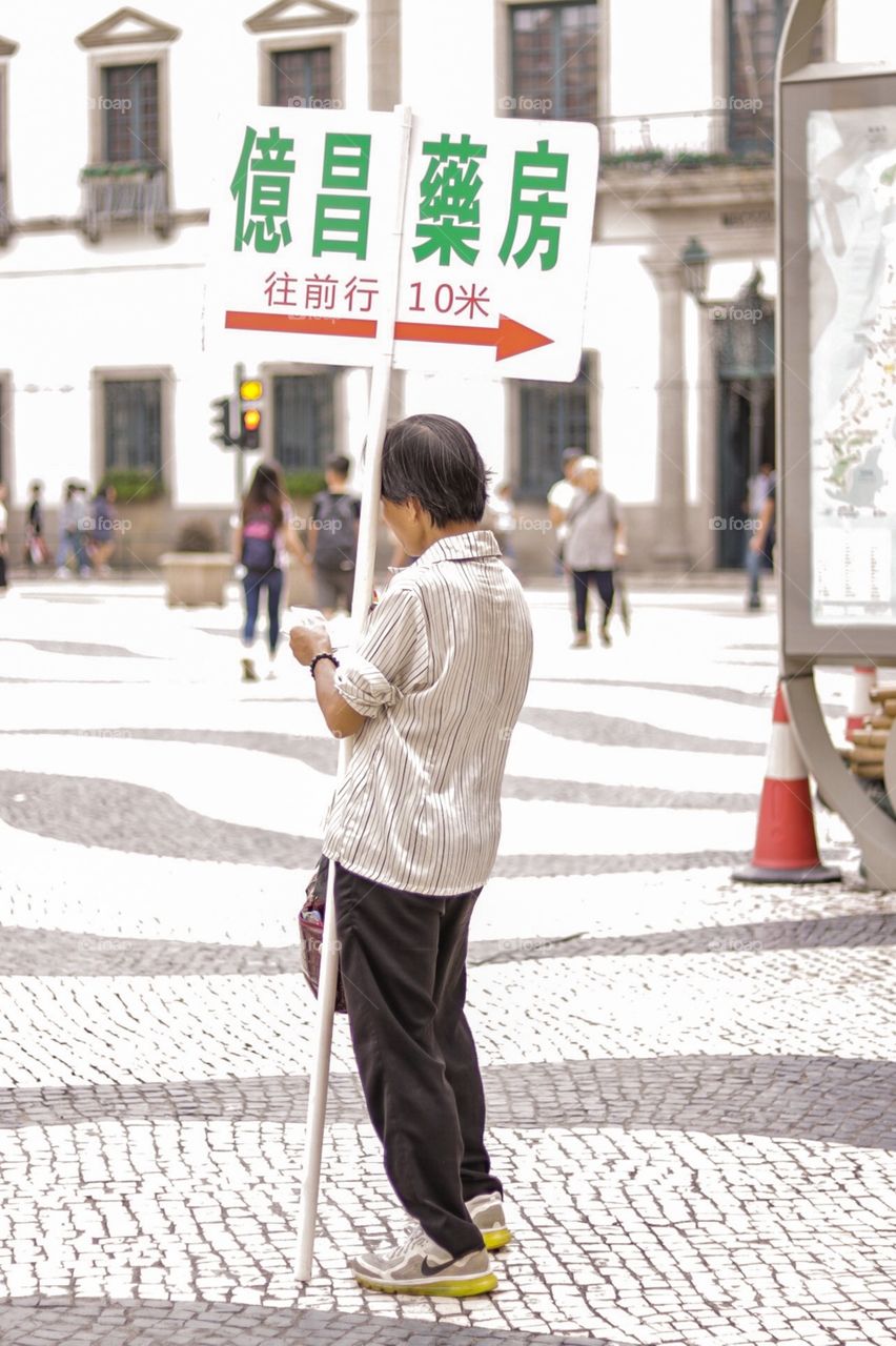 The Moving Commercial signage! Staff While holding the Signage for costumer to see the location of the store..