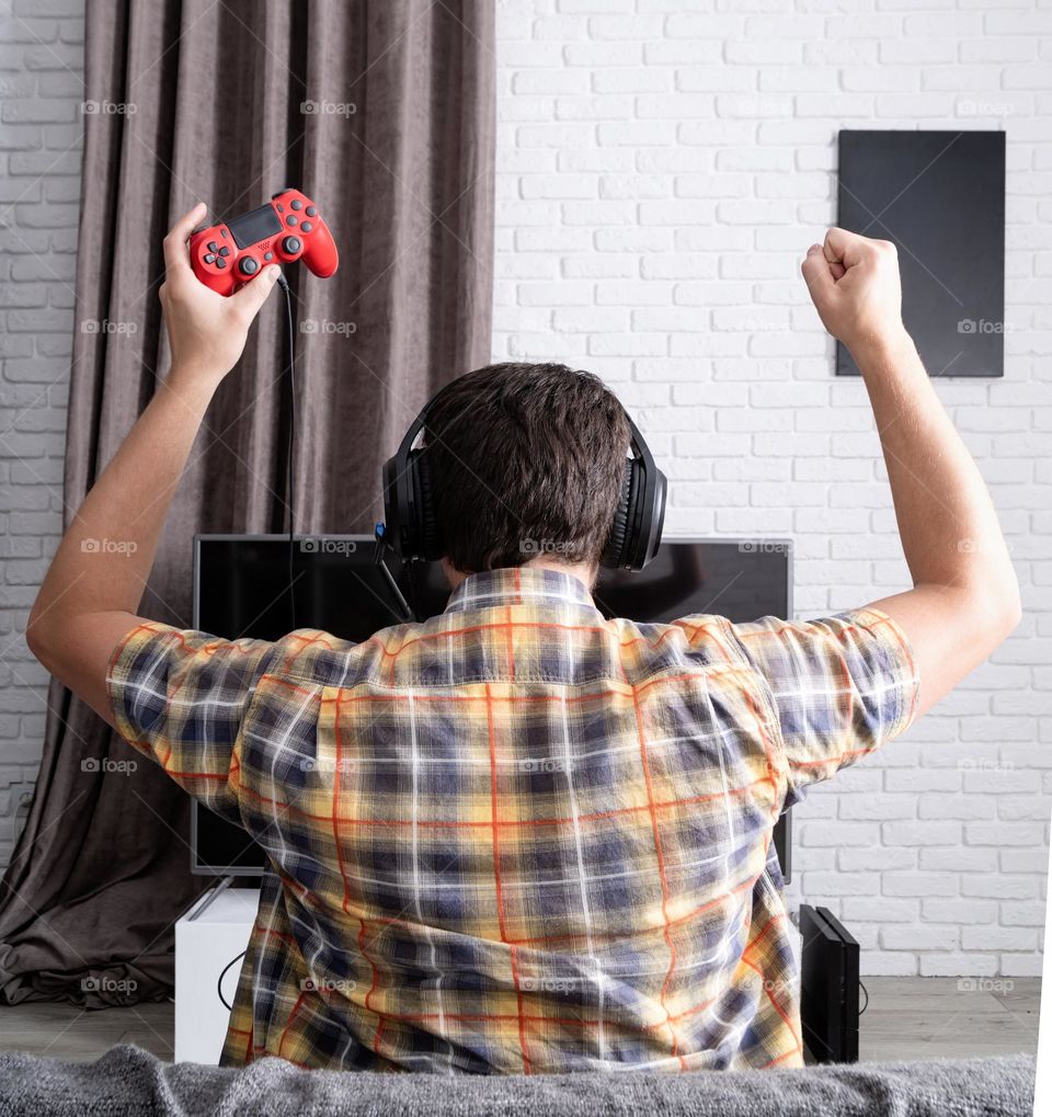 young emotional man playing video games