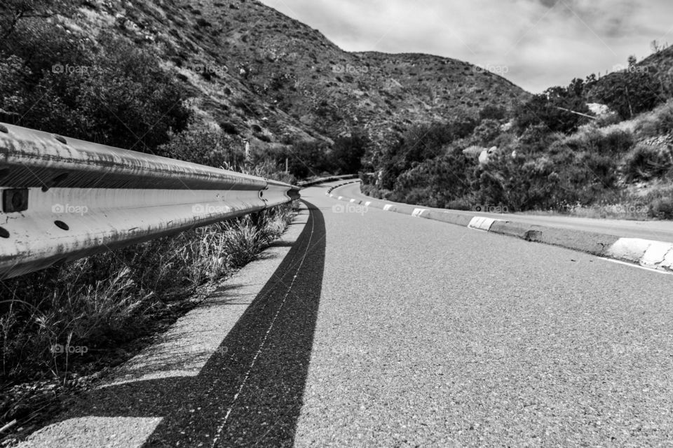 Vehicle perspective on a curvy mountain road.