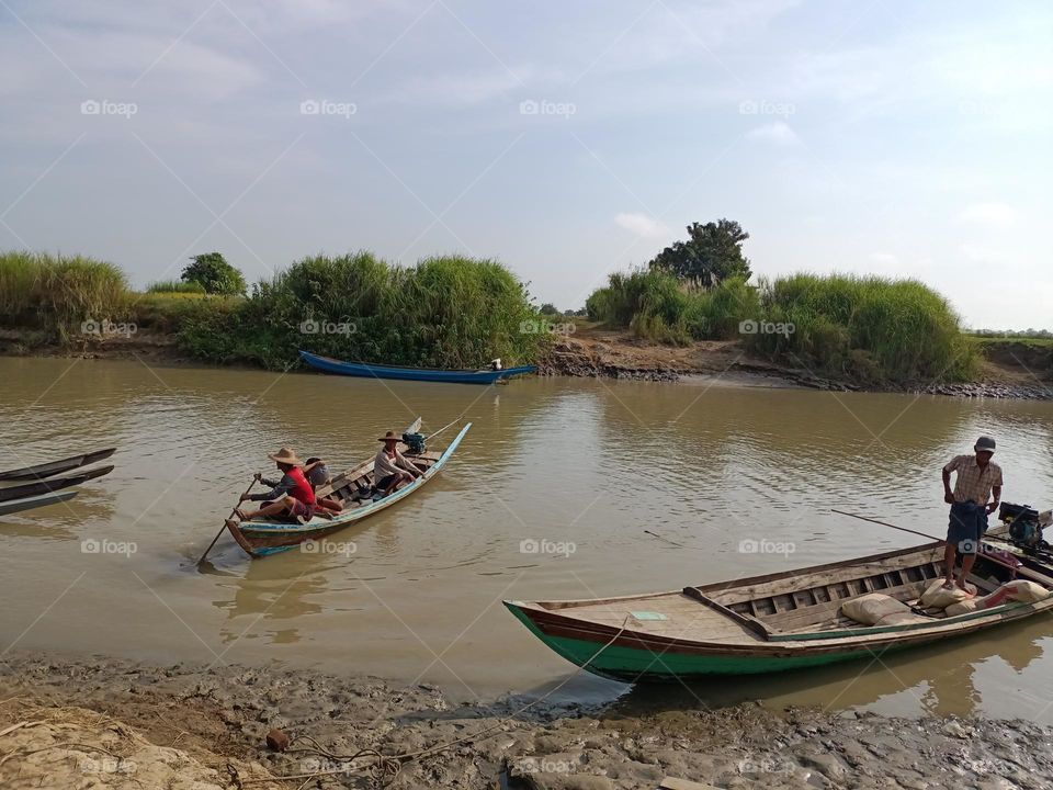 Boat approaching shoreline at the stream in rural area