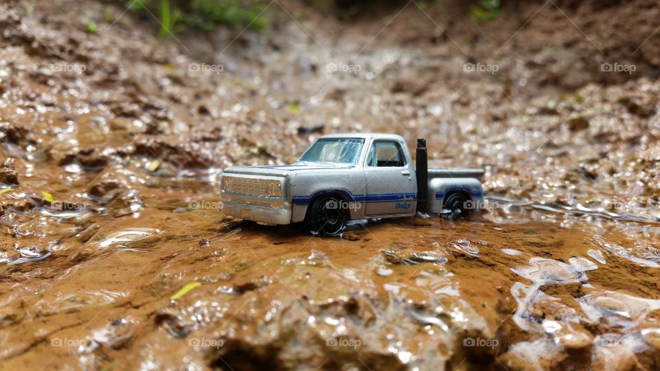 miniature photo of a car crossing a river