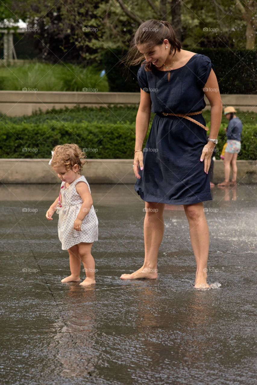 Mother and daughter playing in water