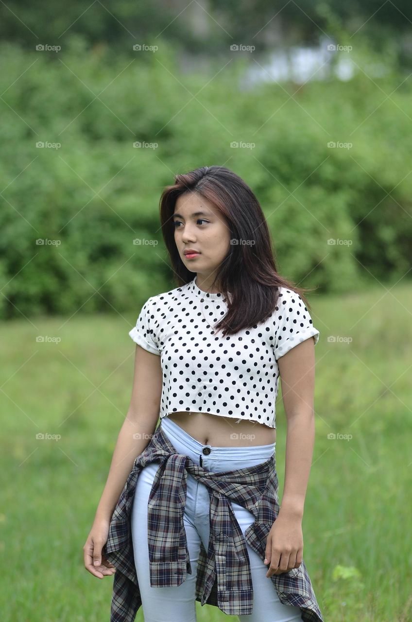 a beautiful girl is posing in casual clothes