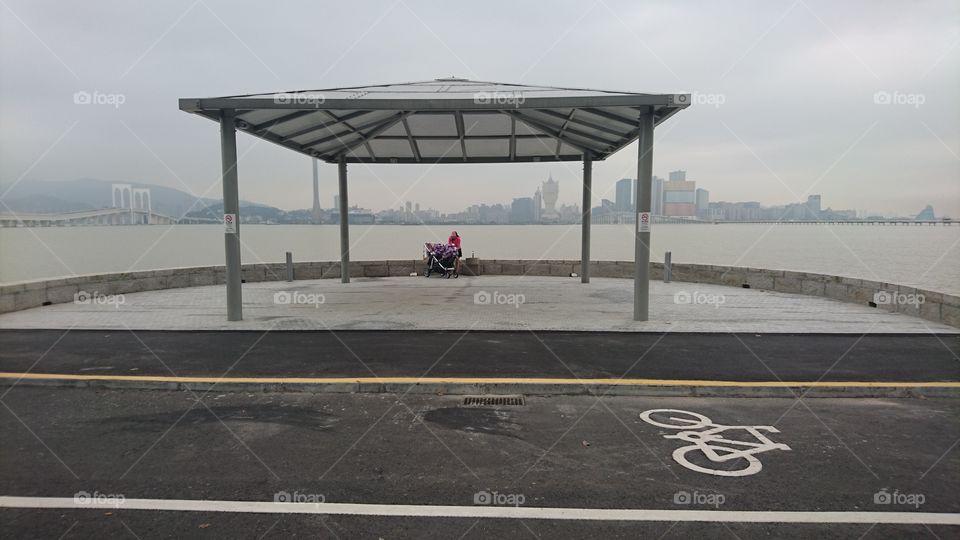 Woman sitting with stroller, Macau