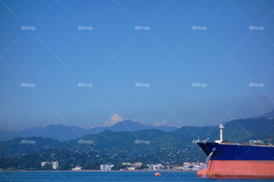 A large size oil tanker floating in Black Sea and unloading water from its tanks while anchored outside oil terminal in Batumi, Georgia on a cloudless sunny day on July10, 2014.