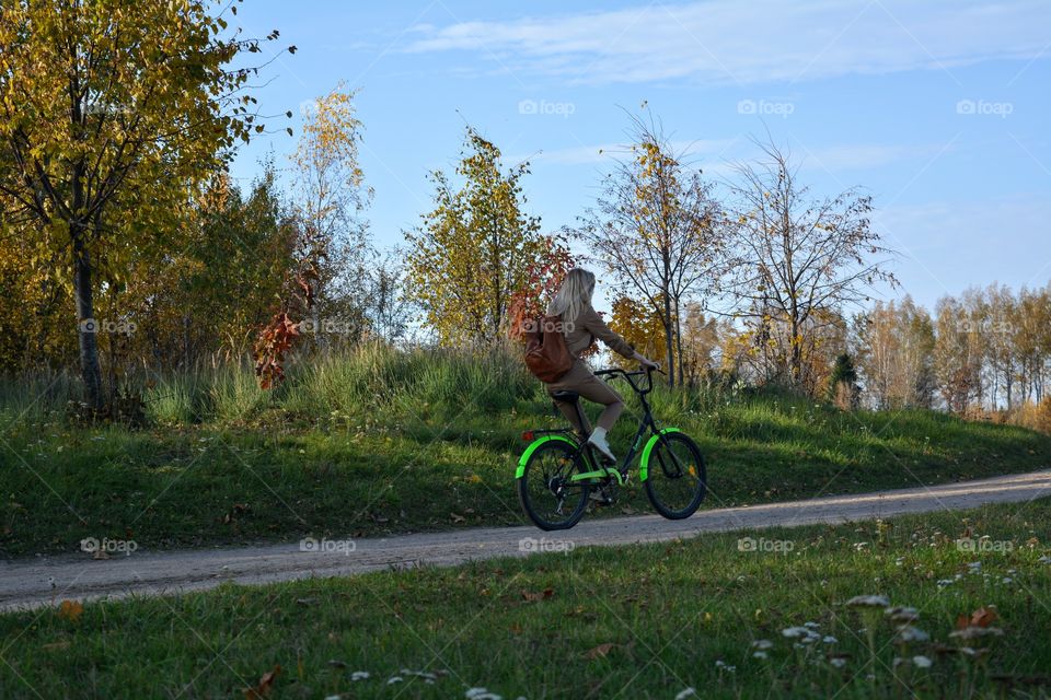 woman riding on a bike autumn beautiful landscape