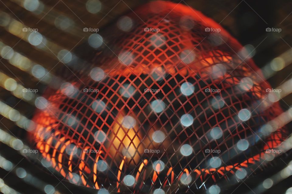 red hot grill and coil with bokeh light foreground