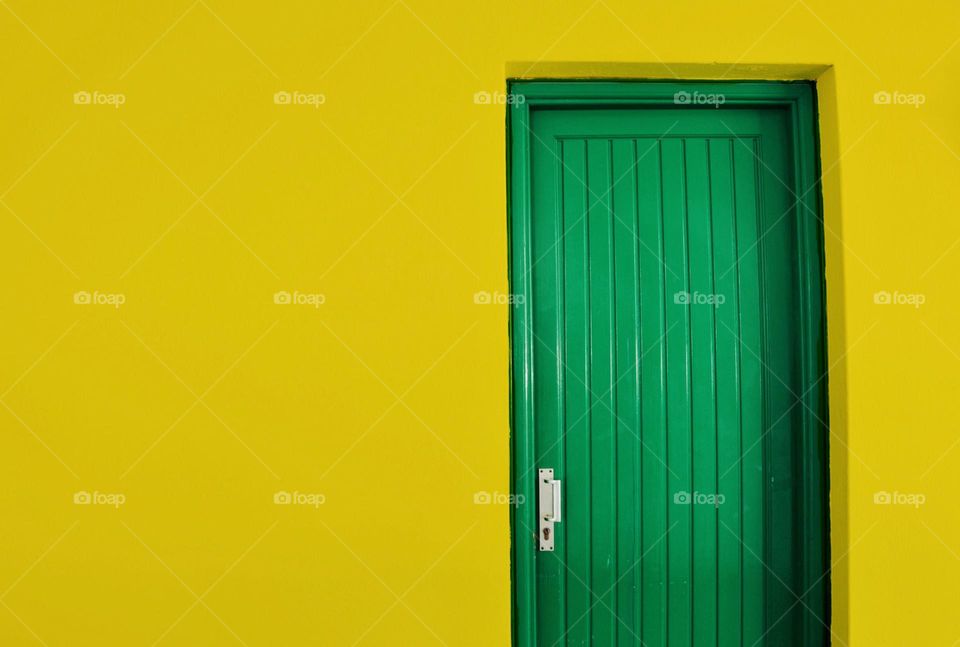 A yellow house with a green door