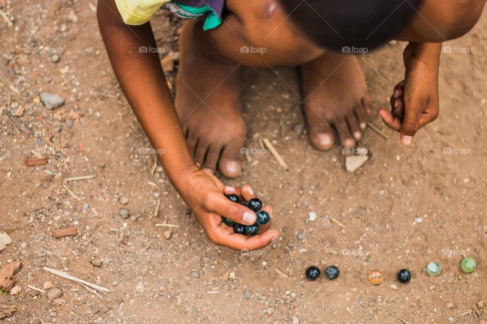 baby playing with marbles