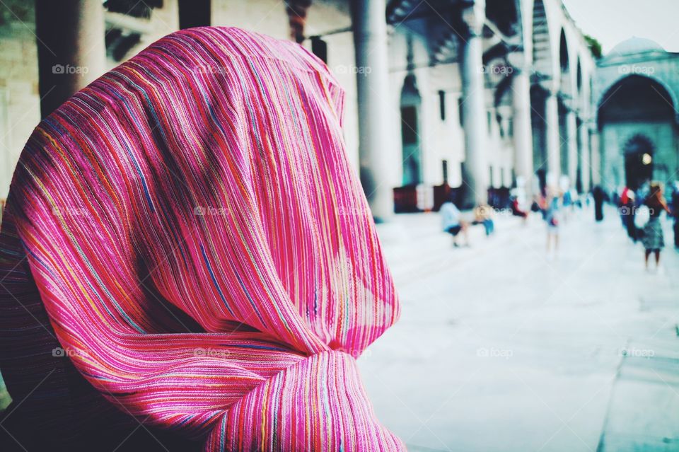 Woman wearing pink scarf