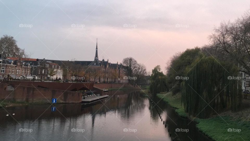A cold autumn morning. The sun rises over a lake in a small town in the Netherlands