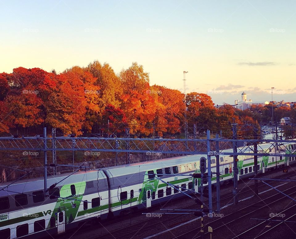 Train along he autumn Helsinki skyline