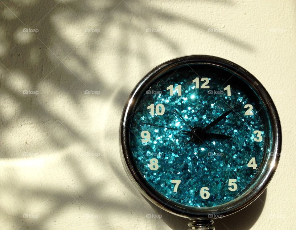 Sparkeling blue clock in the afternoon.