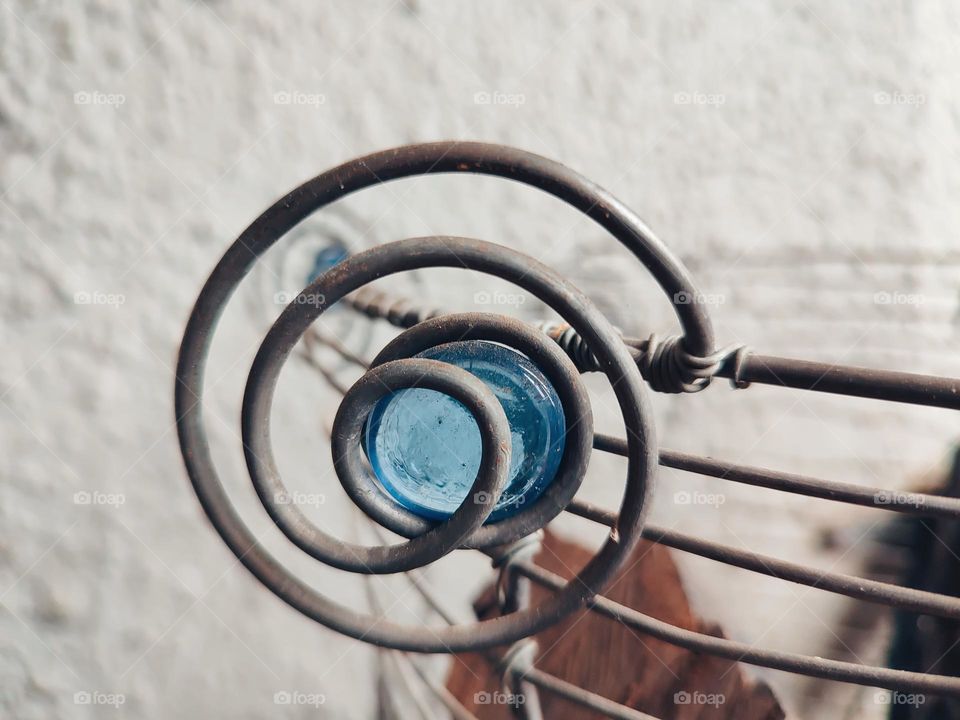 Metal spiral with glass ball