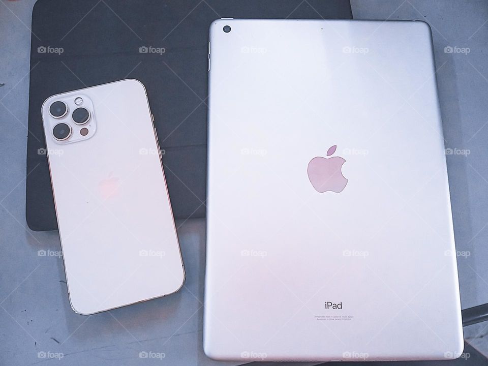 iPhone and iPad on a table. High angle view