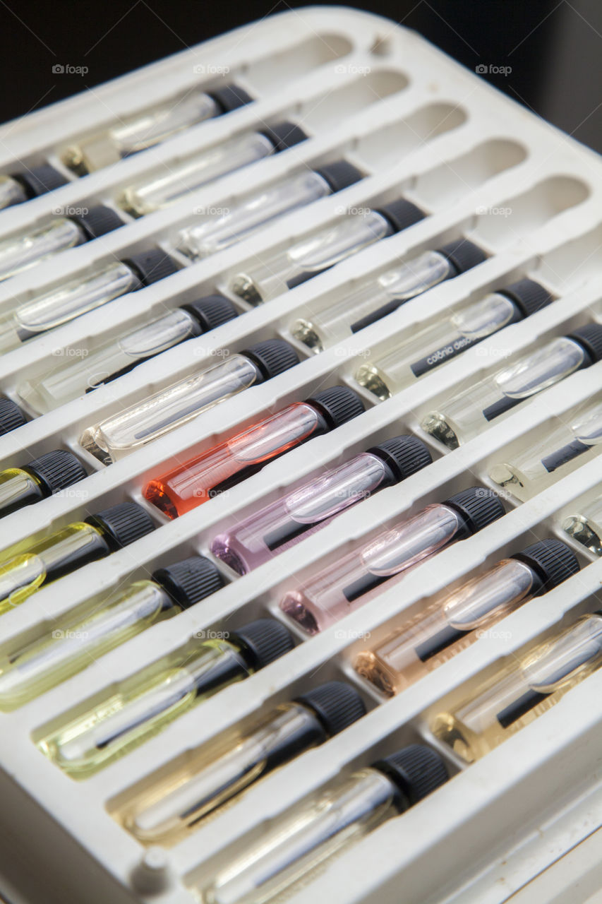 Catalogue with perfume sample bottles, for sale of fragrances of various colors and aromas