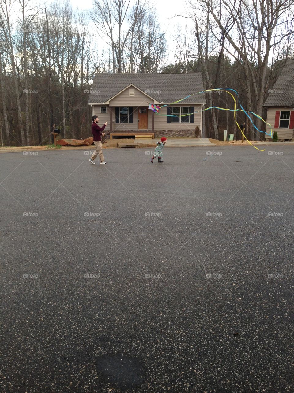 Father playing with son on street