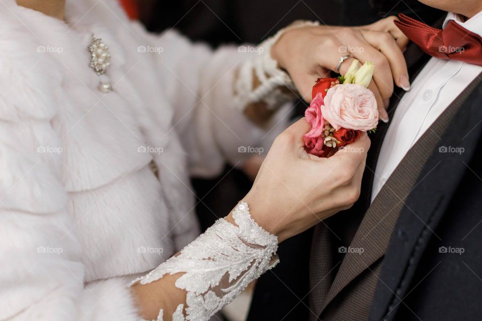 Boutonniere of red and pink roses