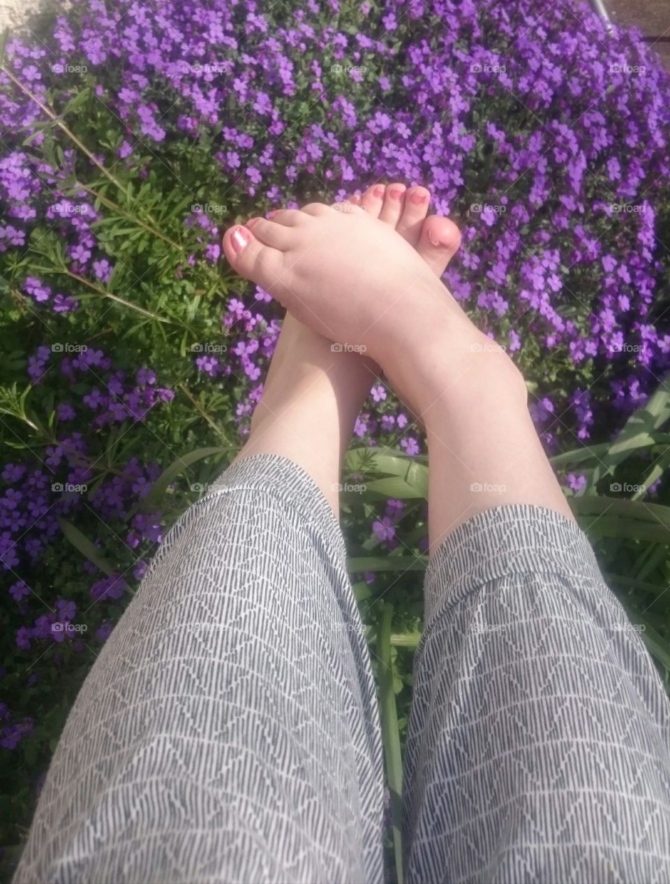 me enjoying the spring with feet on flowers