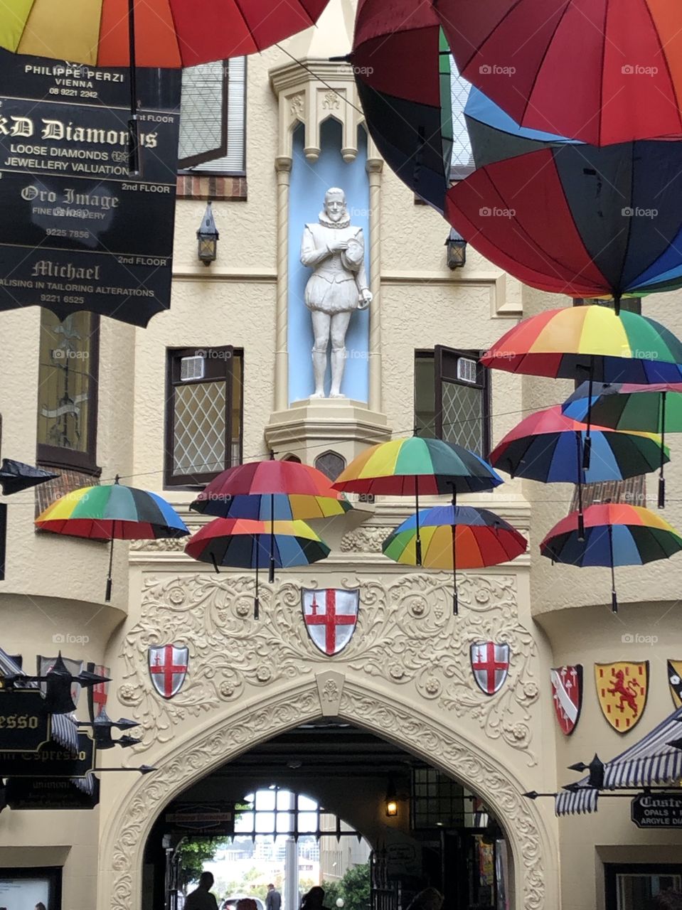 Statue of Sir Walter Raleigh, London Court, Perth Australia - London Court is a retail arcade built in 1937 is running between Hay Street Mall & St Georges Terrace. The colourful umbrellas make happiness to locals and tourists in winter. 