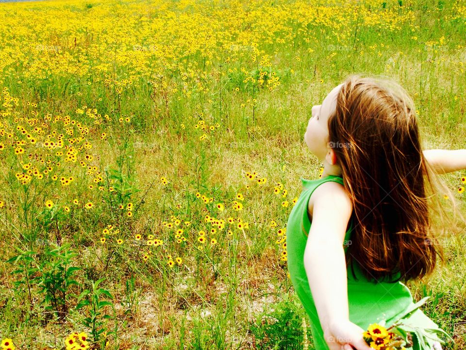 Girl standing in flower field