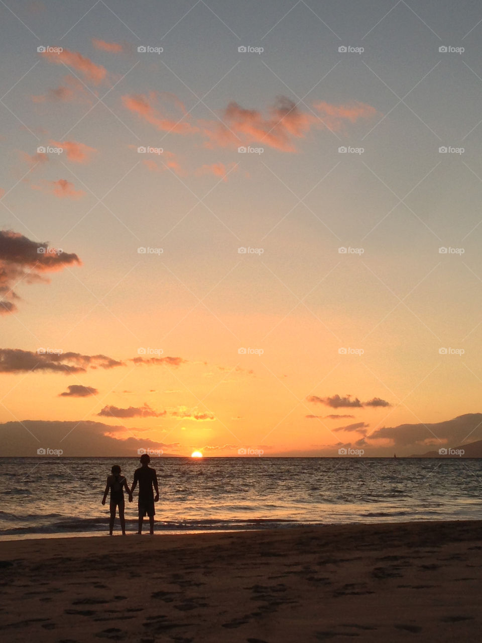 Silhouetted children at beach, Maui
