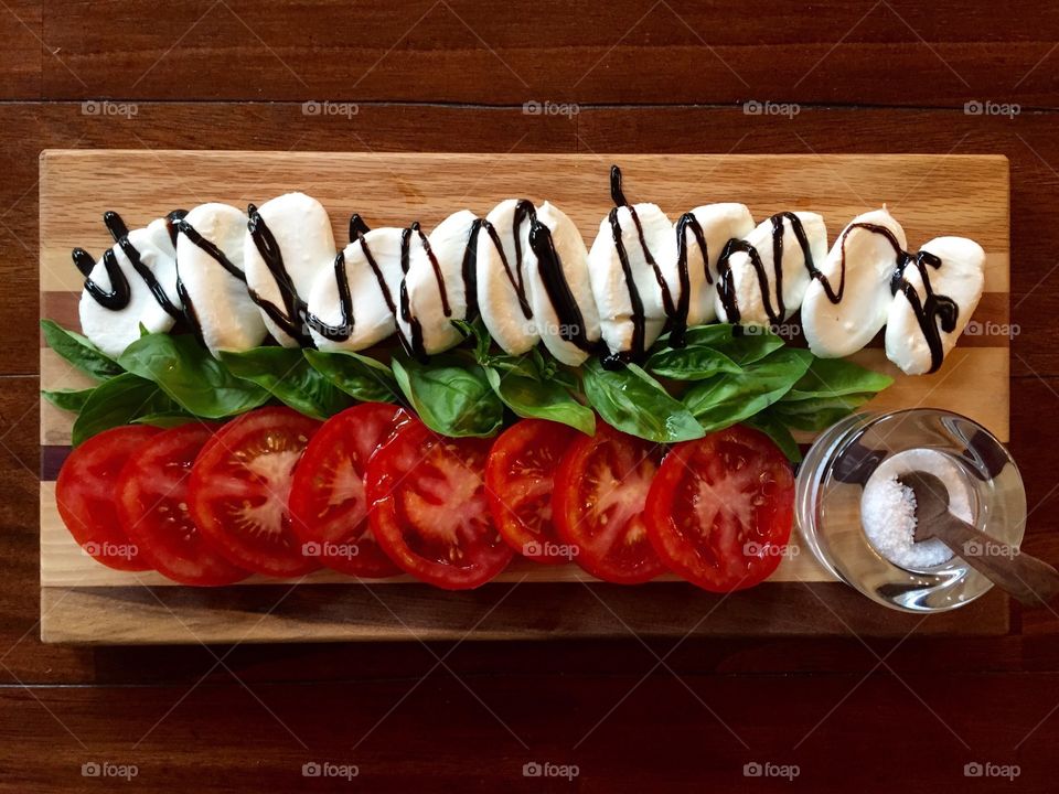 Caprese Salad. Fresh tomatoes & basil with mozzarella drizzled with balsamic glaze and sea salt ready to eat