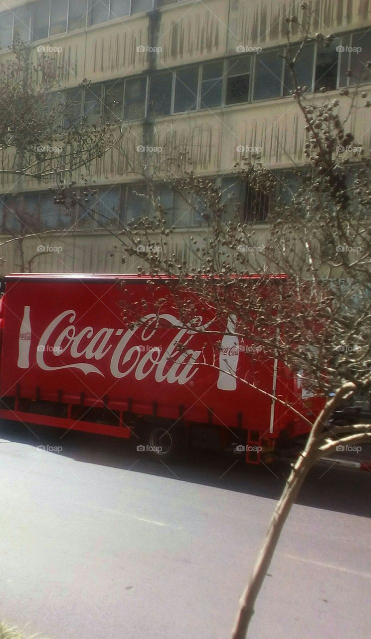 Coca Cola red truck parking in street
in daylight
