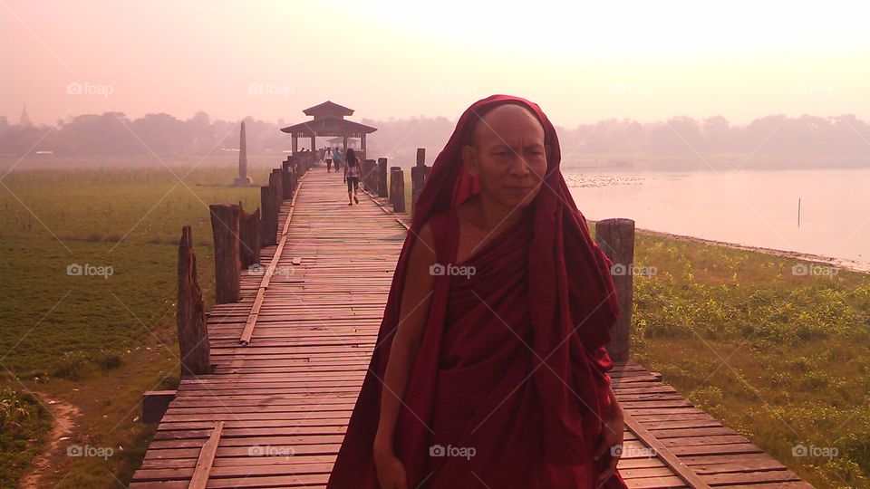 Monk. Myanmar bridge on a spring day, monk walking on a bridge.