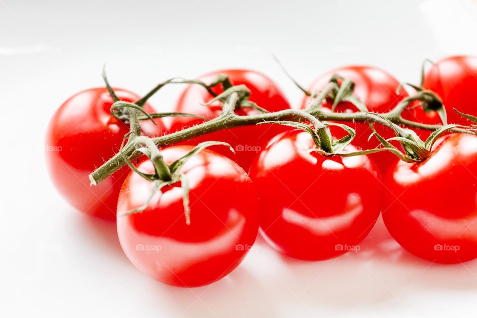 Cherry tomatoes on a white plate, closeup