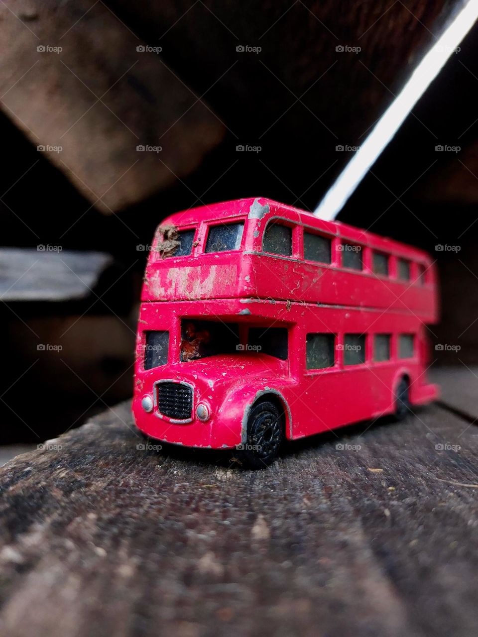 red metal buss toy found outside.