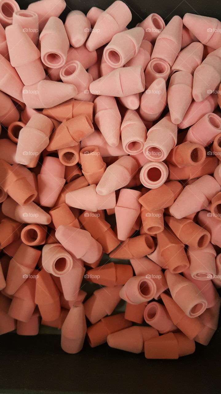pile of pink pencil erasers