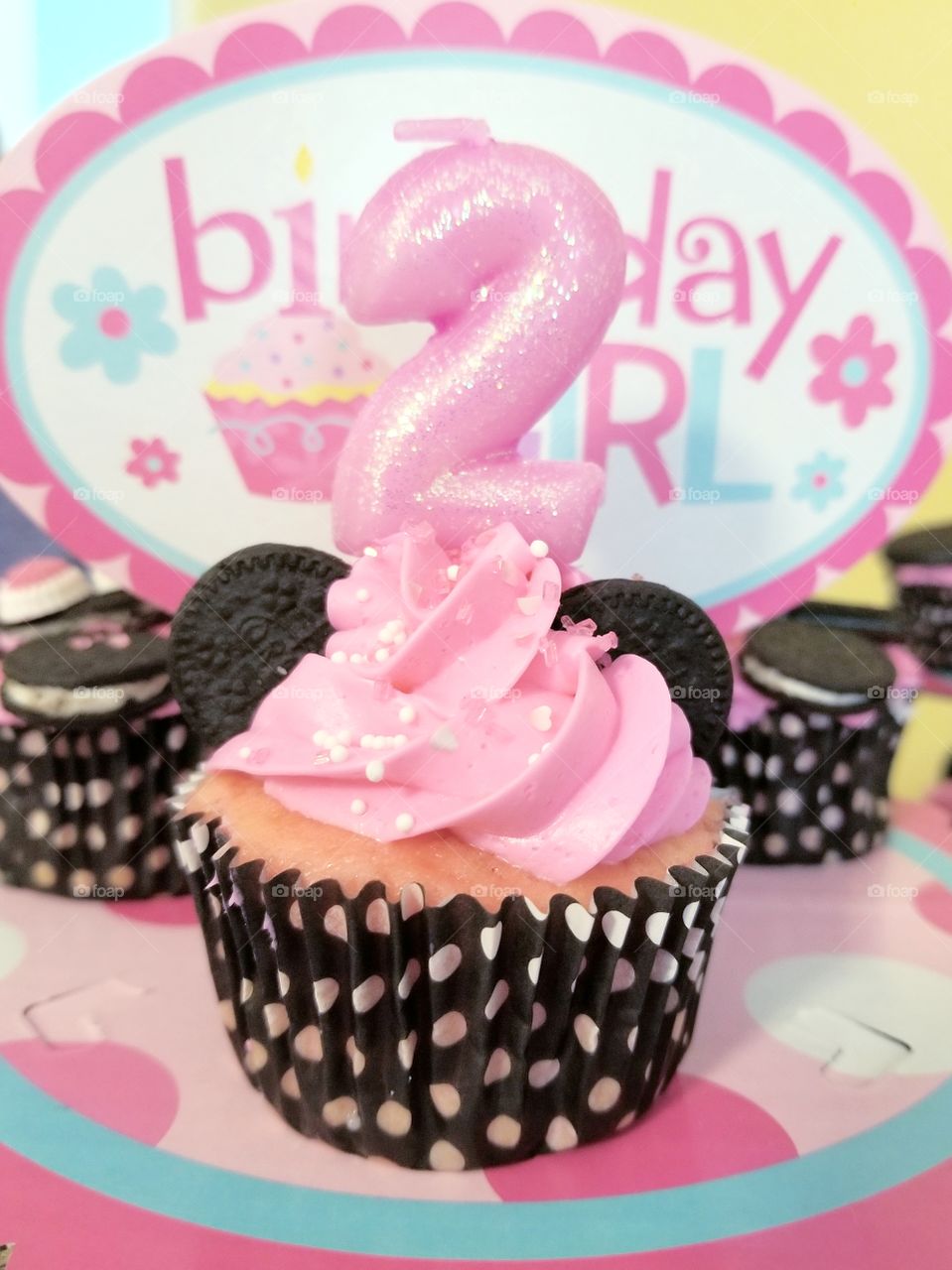 Pink 2nd Birthday Cupcake with a sparkly #2 candle and a spotted cupcake wrapper