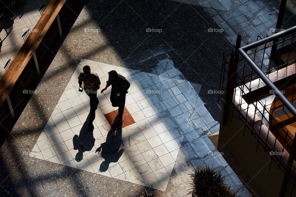 Two businessmen walking in office building