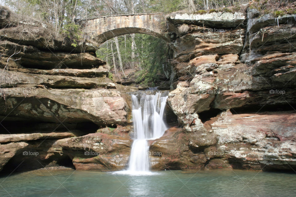 Waterfall under bridge