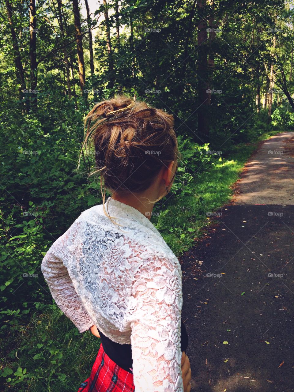 Summertime. Girl looking down the path.