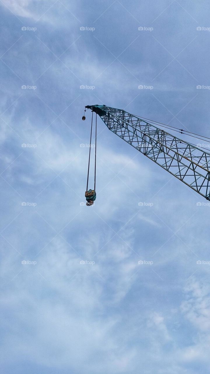 Top boom of crawler crane rise to the sky.