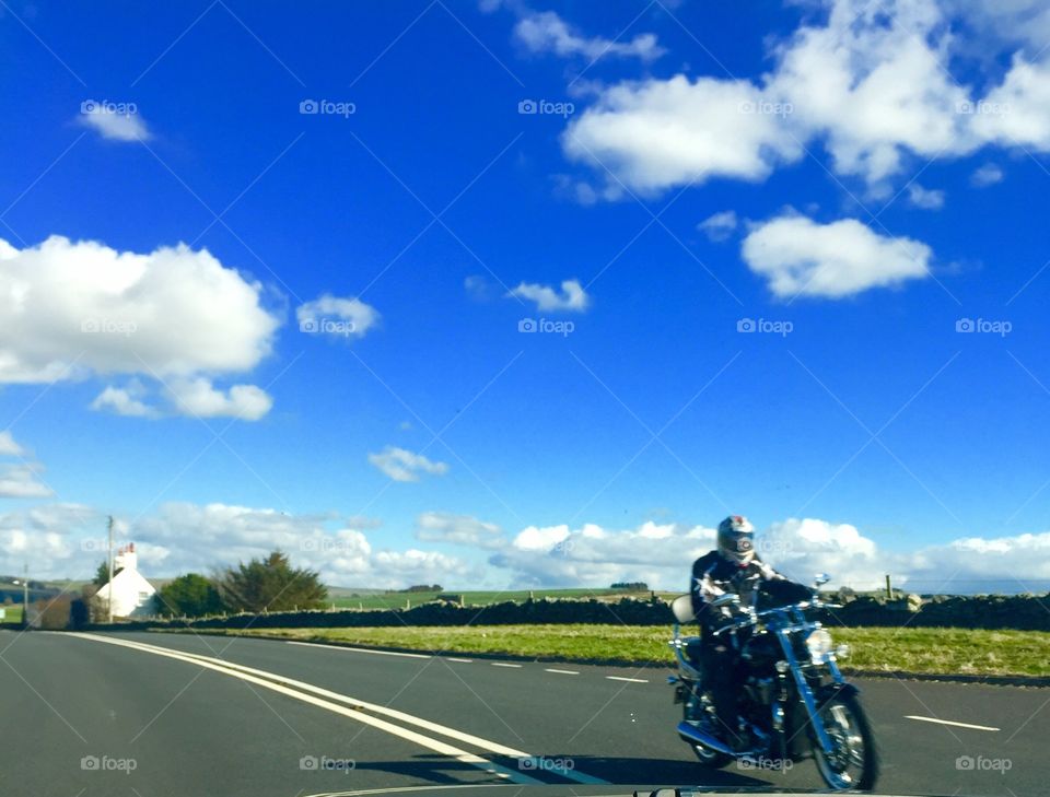 Biker enjoying sun. Biker on move 